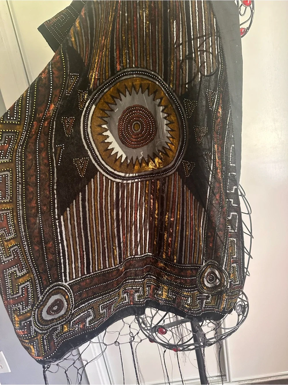 Elegant brown shawl with subtle paisley pattern.